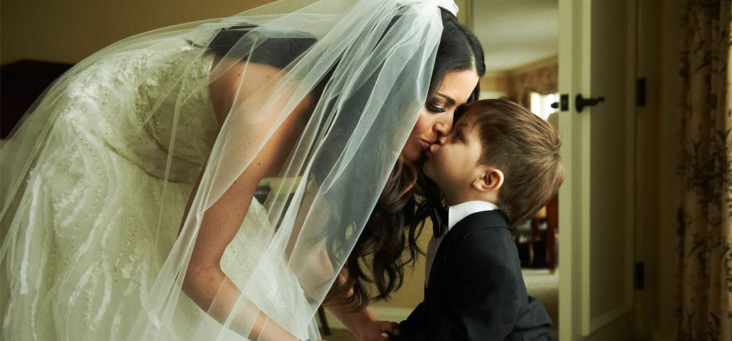 Bride kisses ring bearer while getting ready for wedding in Philadelphia, PA - Event Planner