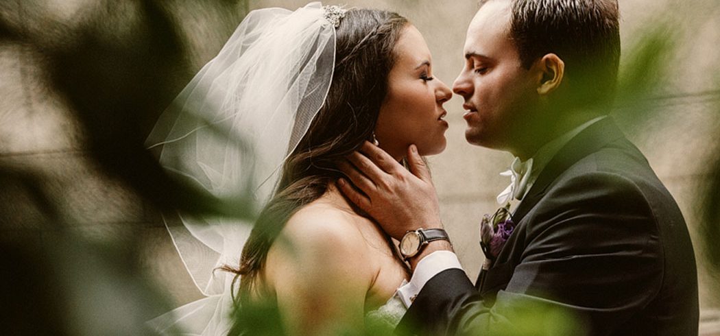 Bride and Groom kiss and embrace and smile during outside wedding portraits in Philadelphia, PA - Event Planner