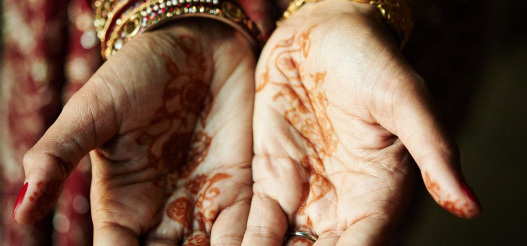 Bride's hands with traditional Indian Mehndi decorations or henna tattoos