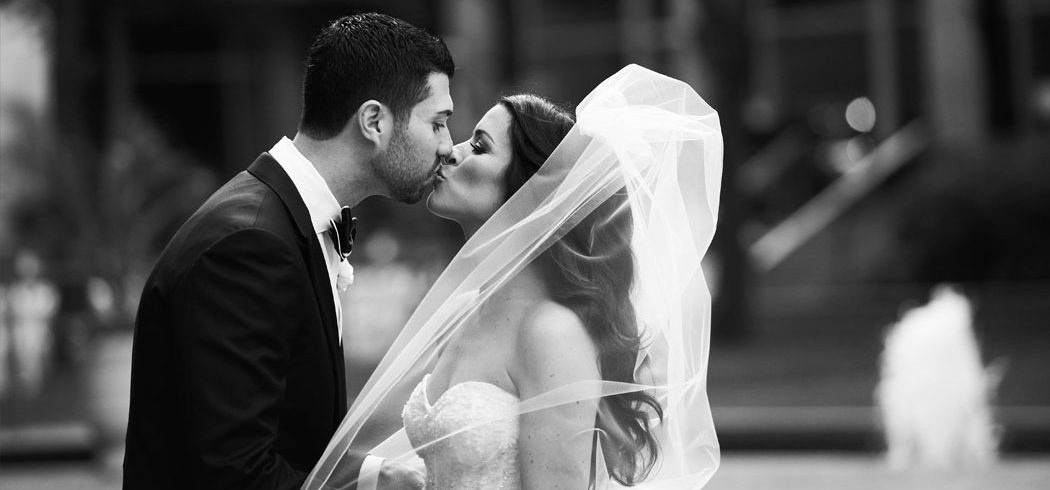 Bride and Groom kiss during outside wedding portraits in Philadelphia, PA - Event Planner