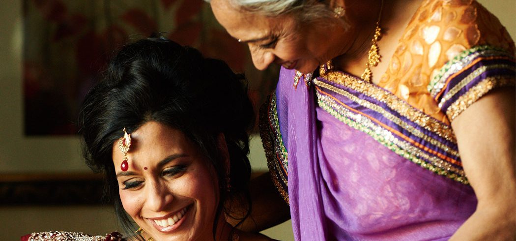 Bride smiling with Mother of the Bride while getting ready for wedding day in Philadelphia, PA - Event Planner