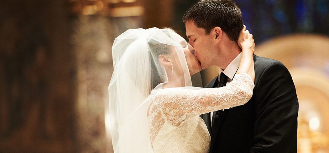 Bride and Groom kiss at wedding ceremony in Church in Philadelphia, PA - Event Planning