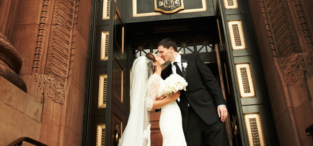 Bride and Groom kiss outside church at wedding in Philadelphia, PA - Event Planner