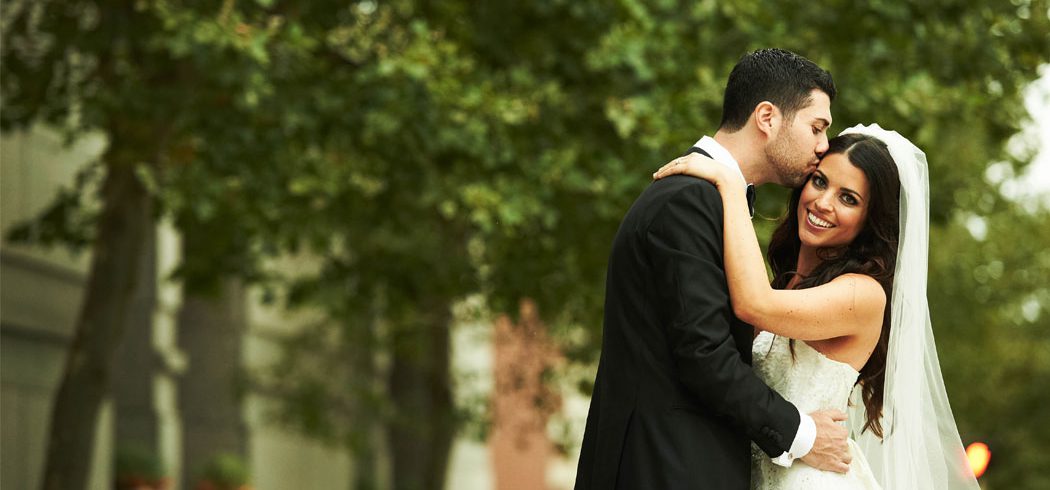 Bride and Groom embrace and smile during outside wedding portraits in Philadelphia, PA - Event Planner