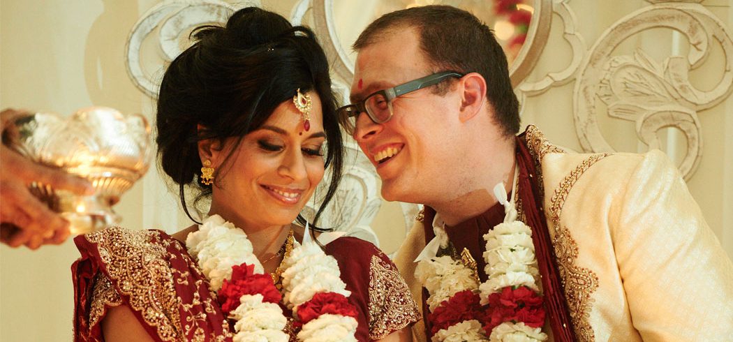 Bride and Groom whisper and laugh during traditional Indian wedding ceremony in Philadelphia, PA - Event Planner