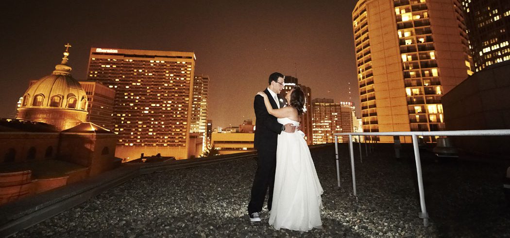 Bride and Groom dance during outside rooftop nighttime wedding portraits in Philadelphia, PA - Event Planner