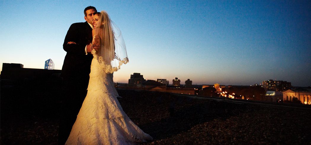 Bride and Groom on rooftop outside nighttime wedding portraits in Philadelphia, PA - Event Planner